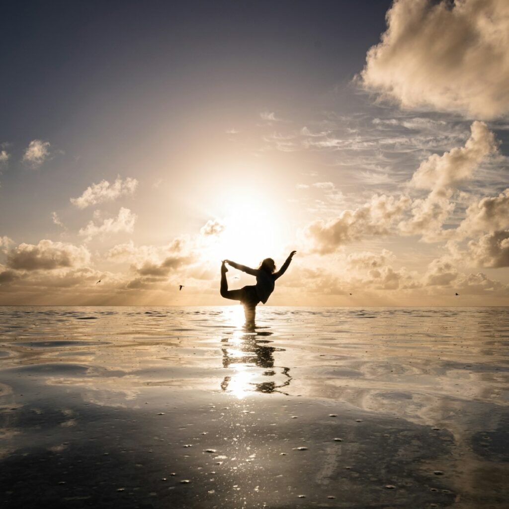 a person standing in the water doing a yoga pose