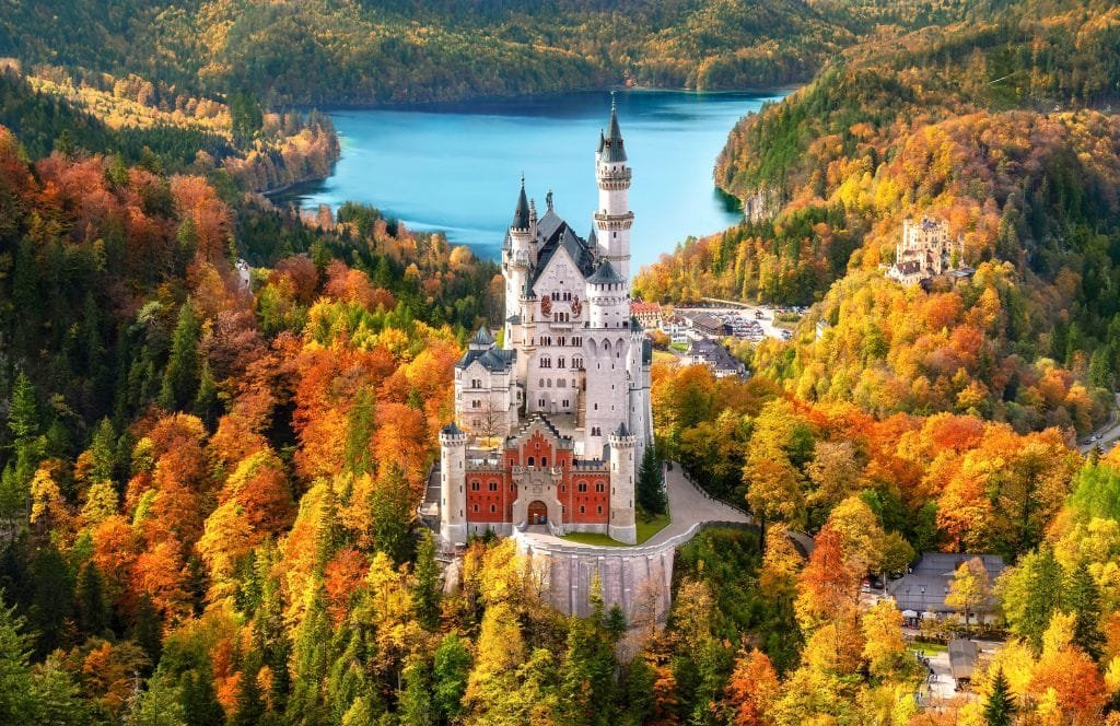 Neuschwanstein Castle surrounded by autumn foliage in Bavaria, Germany